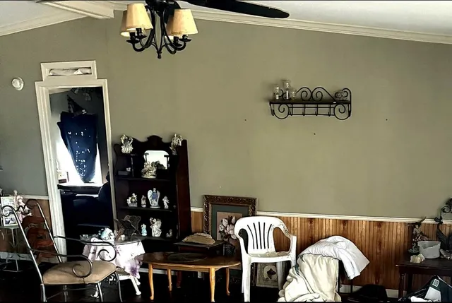 a view of a dining room with furniture and chandelier