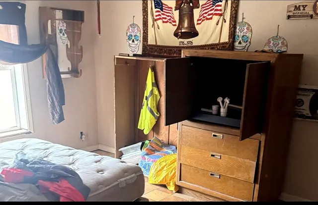 a bedroom with a bed and a window