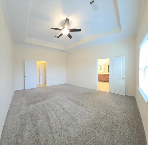 a bathroom with a tub a double vanity sink and mirror