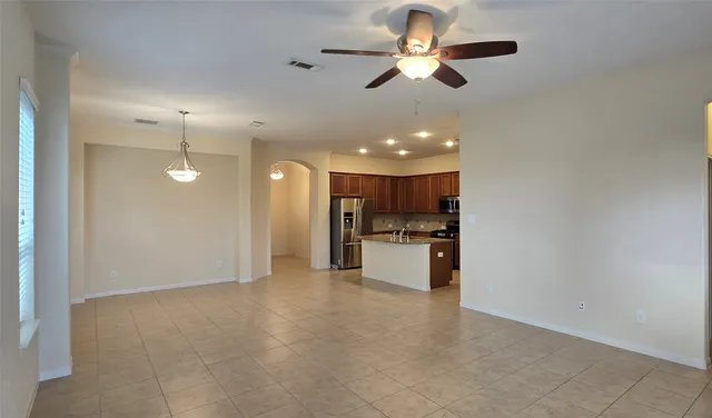 a view of a kitchen with a sink a ceiling fan and kitchen view
