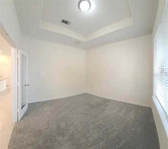 an empty room with windows and entrance