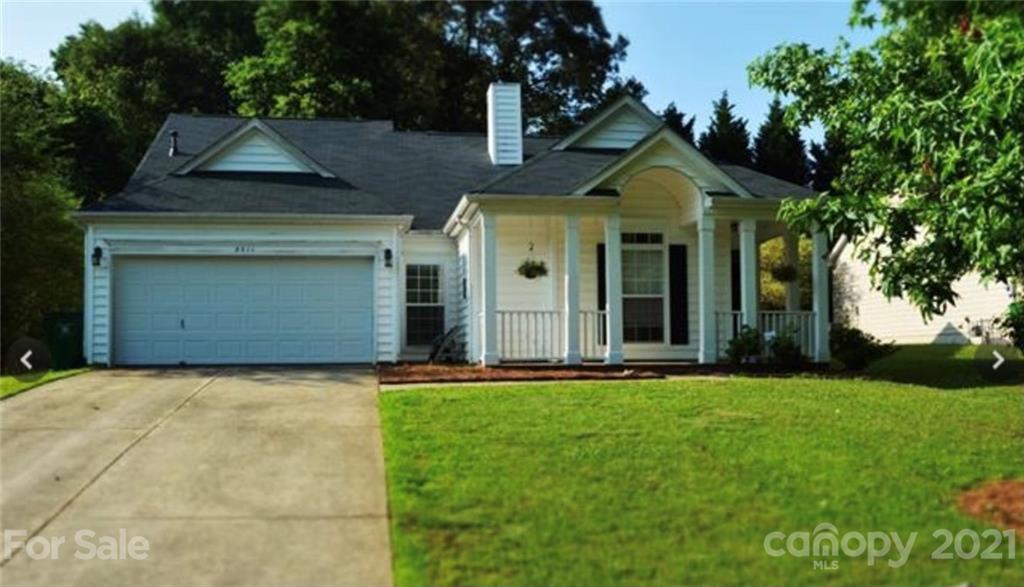 8311 Springhead Lane Charlotte, NC 28215 - Photo 1 of 11 a front view of a house with a yard and garage