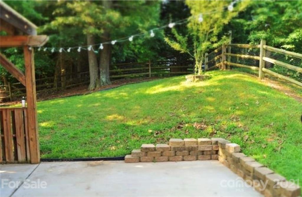 8311 Springhead Lane Charlotte, NC 28215 - Photo 11 of 11 a backyard of a house with fountain table and chairs