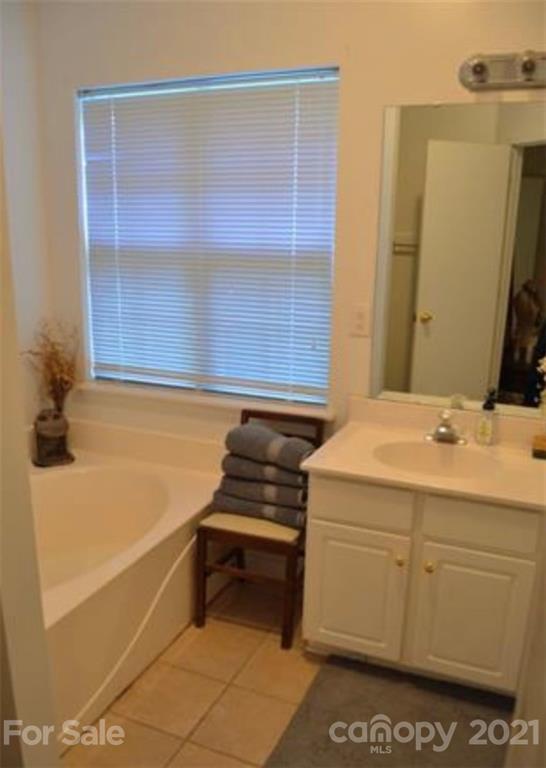 8311 Springhead Lane Charlotte, NC 28215 - Photo 4 of 11 a bathroom with a sink and a mirror