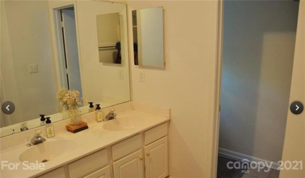 8311 Springhead Lane Charlotte, NC 28215 - Photo 5 of 11 a bathroom with a sink and a mirror