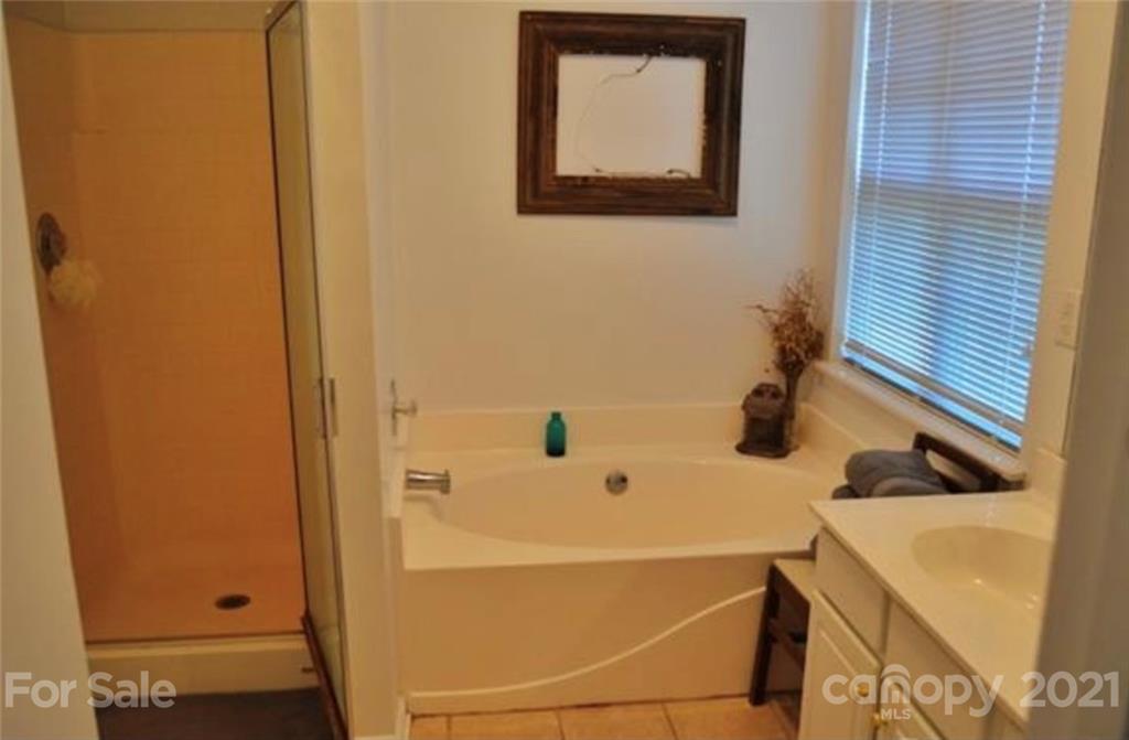 8311 Springhead Lane Charlotte, NC 28215 - Photo 6 of 11 a bathroom with a sink and mirror
