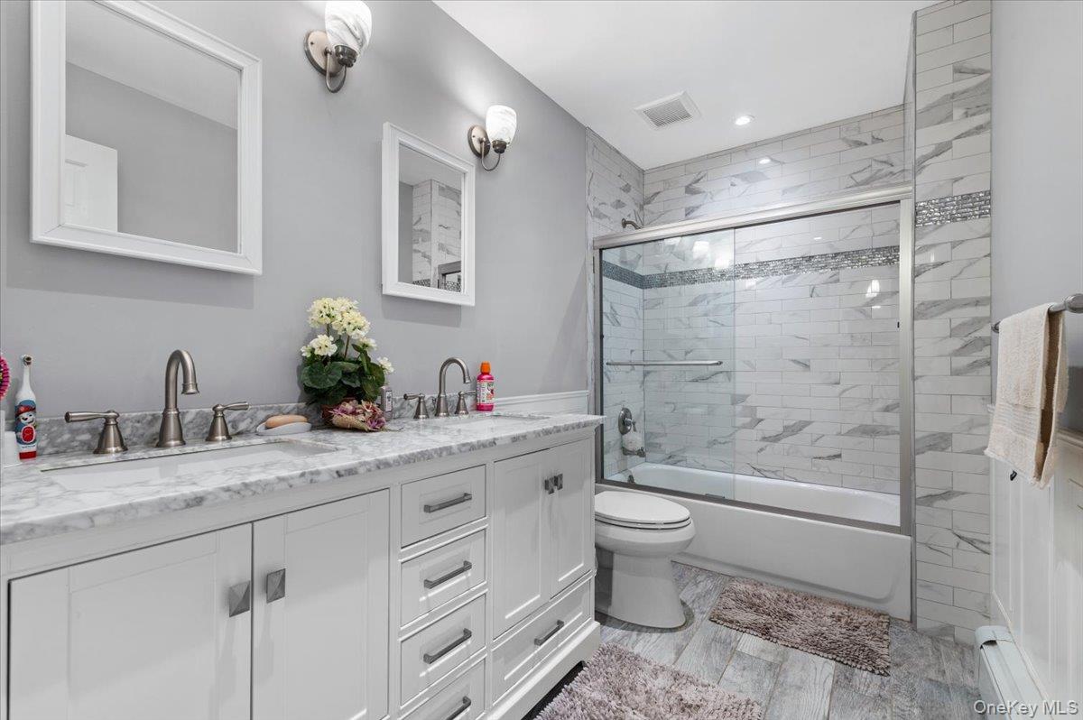 61 Winthrop Road Plainview, NY 11803 - Photo 17 of 37 a bathroom with a granite countertop sink a toilet and shower