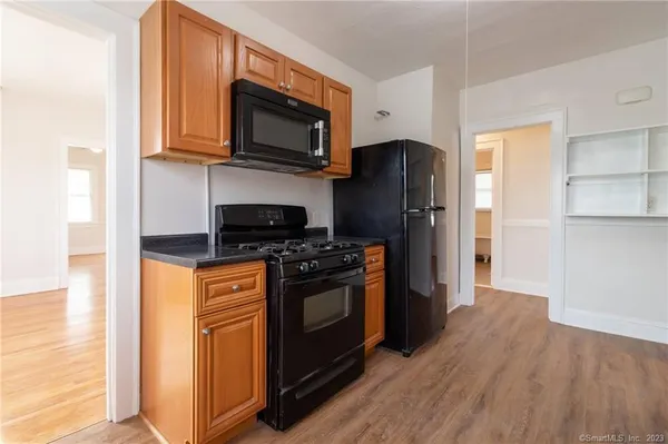 a kitchen with stainless steel appliances granite countertop a refrigerator stove and microwave