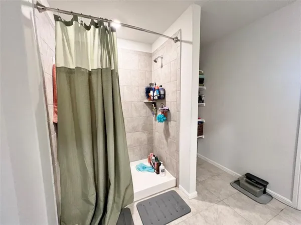 a bathroom with a shower and a mirror