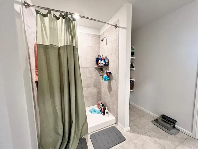 a bathroom with a shower and a mirror