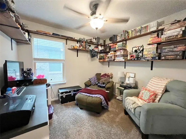a kids room with furniture and a flat screen tv