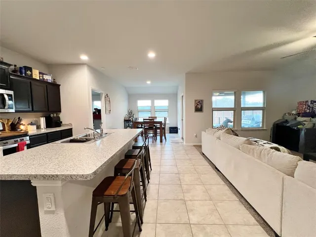 a large kitchen with a table and chairs
