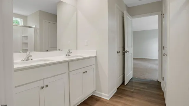 a bathroom with a double vanity sink and mirror