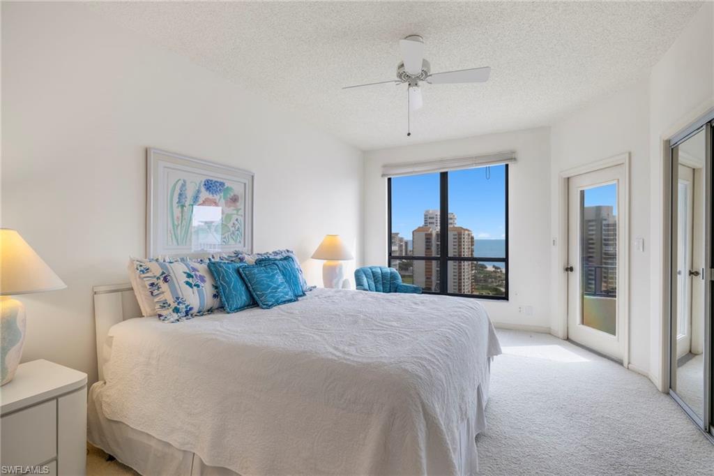 4451 Gulf Shore Boulevard North, Unit 2002 Naples, FL 34103 - Photo 12 of 42 a bed room with a bed and a view of bathroom