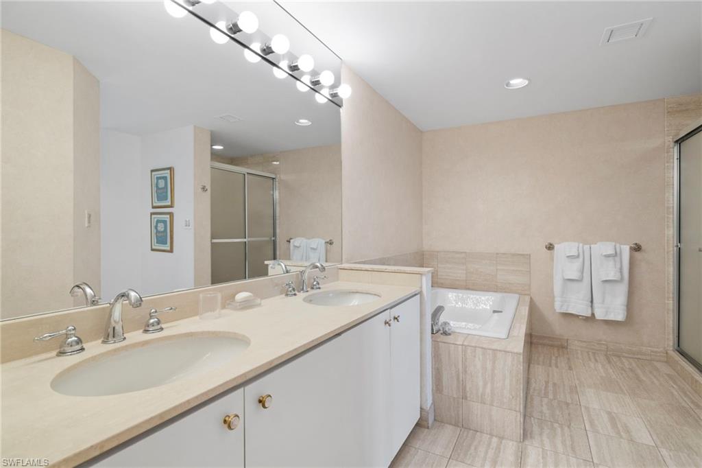 4451 Gulf Shore Boulevard North, Unit 2002 Naples, FL 34103 - Photo 15 of 42 a bathroom with a sink double vanity and a mirror