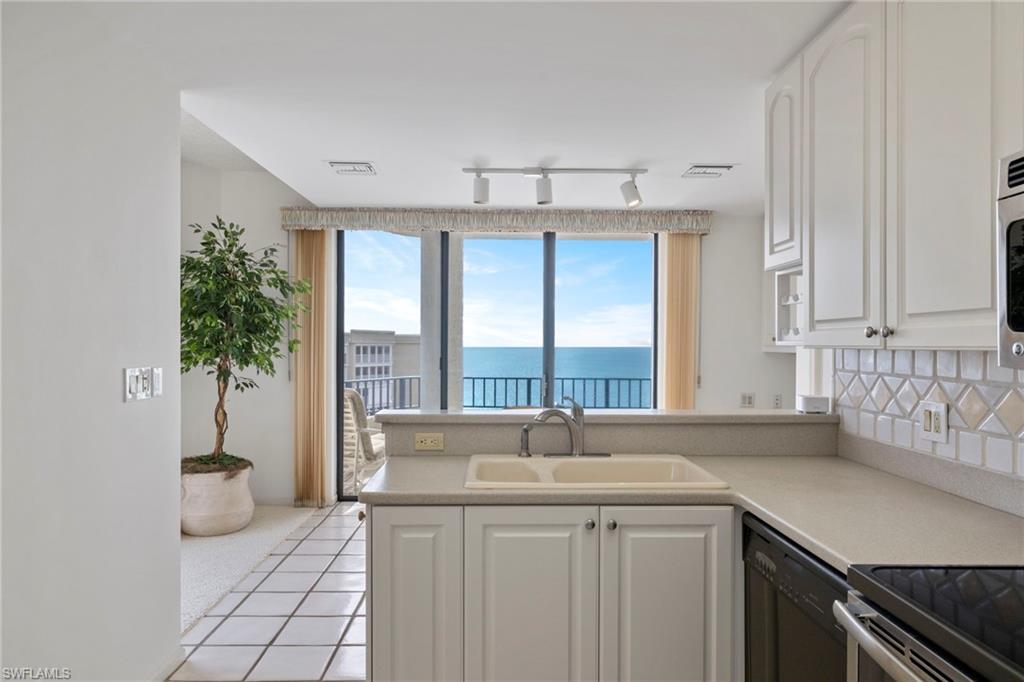 4451 Gulf Shore Boulevard North, Unit 2002 Naples, FL 34103 - Photo 2 of 42 a view of a kitchen with a sink and large window