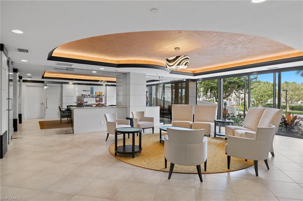 4451 Gulf Shore Boulevard North, Unit 2002 Naples, FL 34103 - Photo 40 of 42 a living room with furniture and a large window