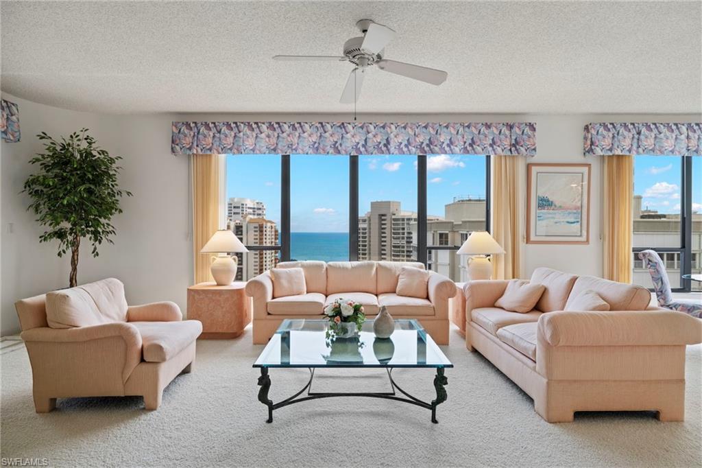 4451 Gulf Shore Boulevard North, Unit 2002 Naples, FL 34103 - Photo 5 of 42 a living room with furniture and a large window