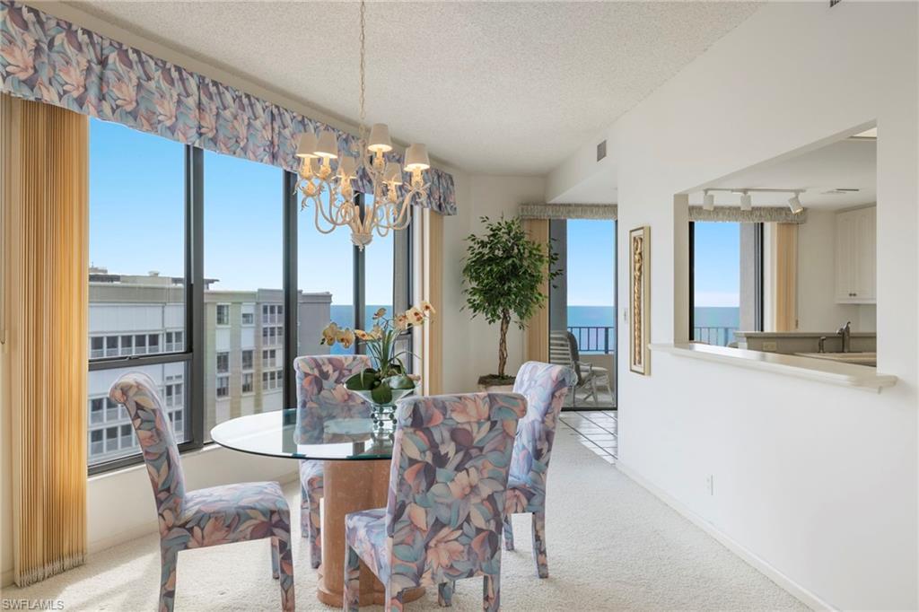 4451 Gulf Shore Boulevard North, Unit 2002 Naples, FL 34103 - Photo 10 of 42 a view of a dining room with furniture window and outside view