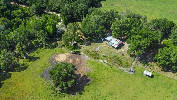 an aerial view of residential house with green space