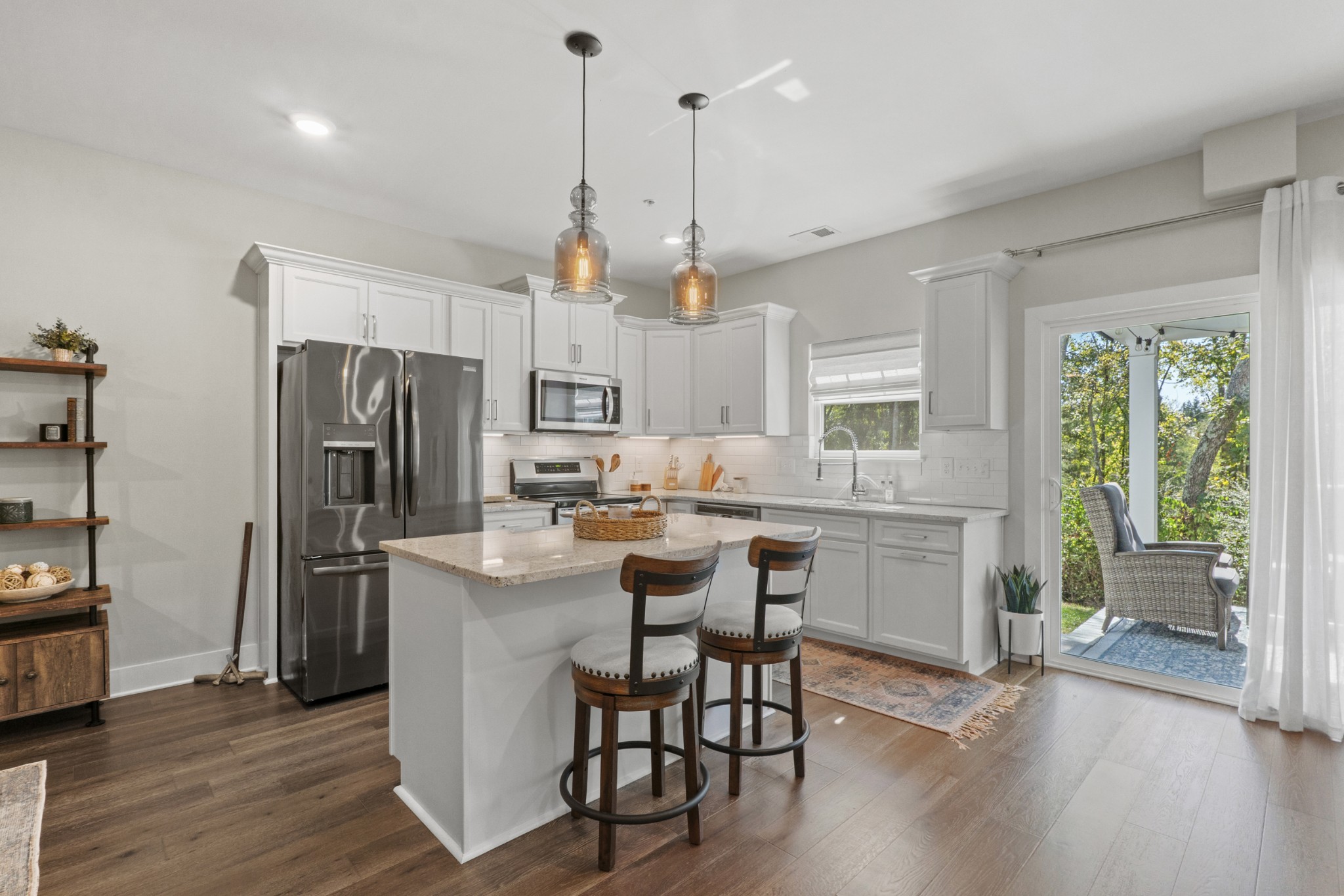1144 Lock 4 Road, Unit J4 Gallatin, TN 37066 - Photo 12 of 50 a kitchen with stainless steel appliances a dining table chairs stove and refrigerator