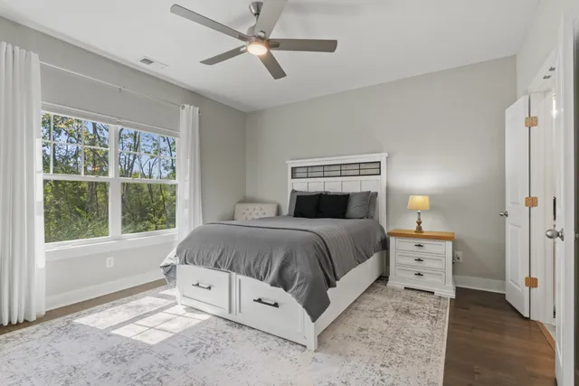 a spacious bedroom with a bed and a window