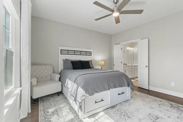 a bedroom with a white bed and white walls
