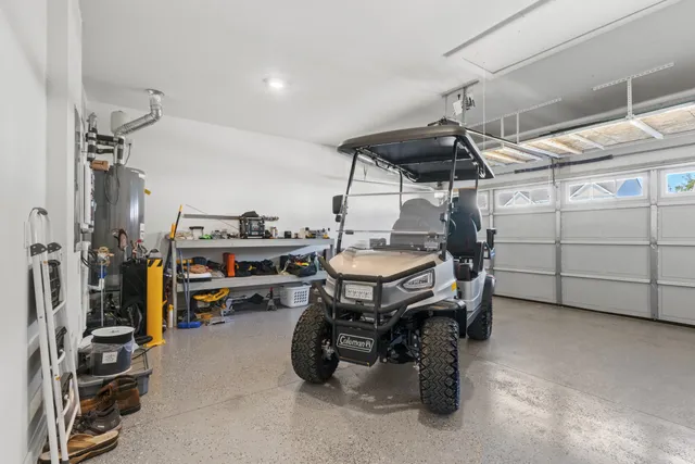 a kitchen with stainless steel appliances a sink a stove a table and chairs