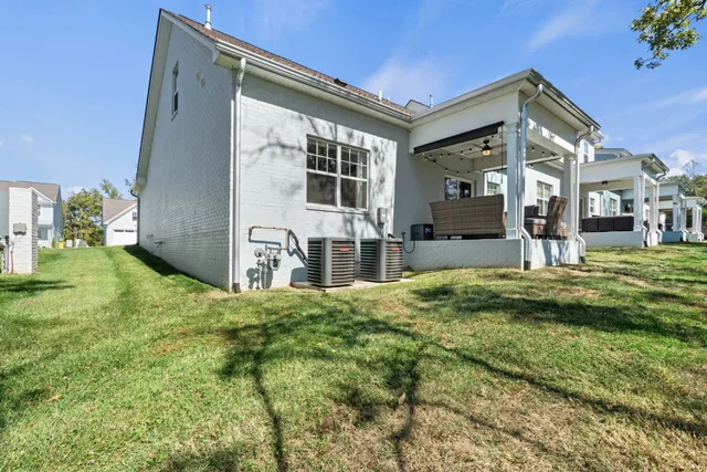 an aerial view of house with backyard space and ocean view