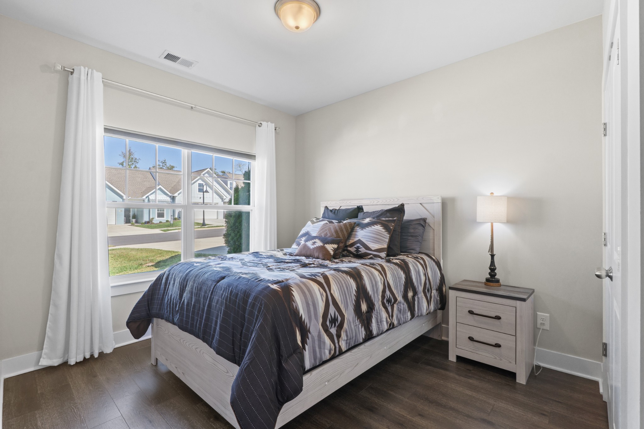 1144 Lock 4 Road, Unit J4 Gallatin, TN 37066 - Photo 5 of 50 a bed sitting in a bedroom next to a window