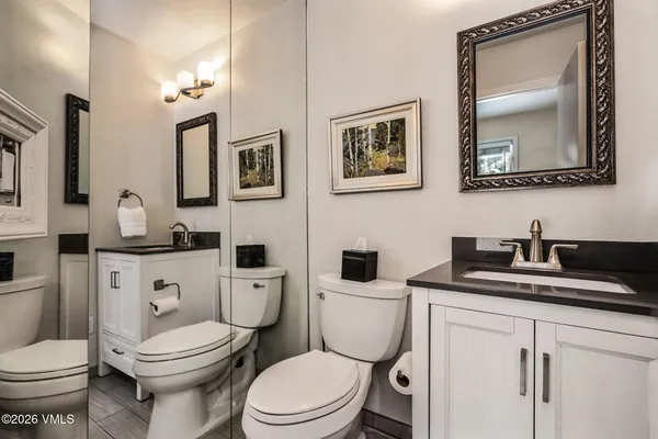 a white toilet sitting next to a bathroom sink