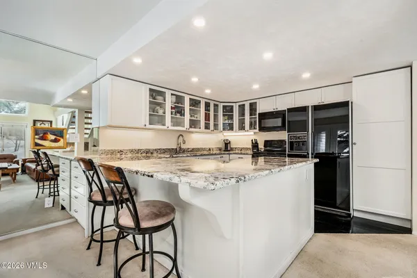 a kitchen with stainless steel appliances granite countertop a stove and refrigerator