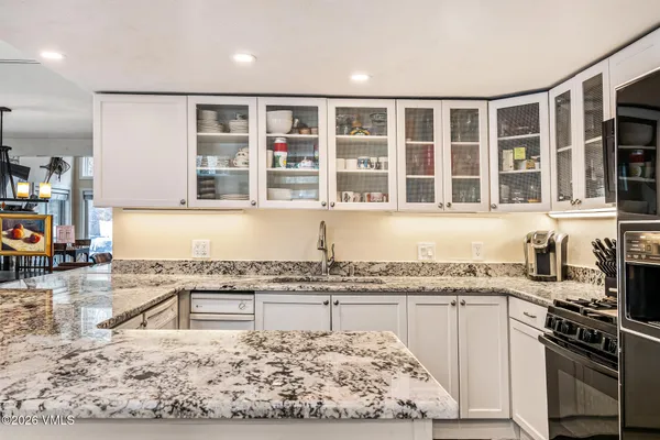 a kitchen with granite countertop a stove a sink and a granite counter tops