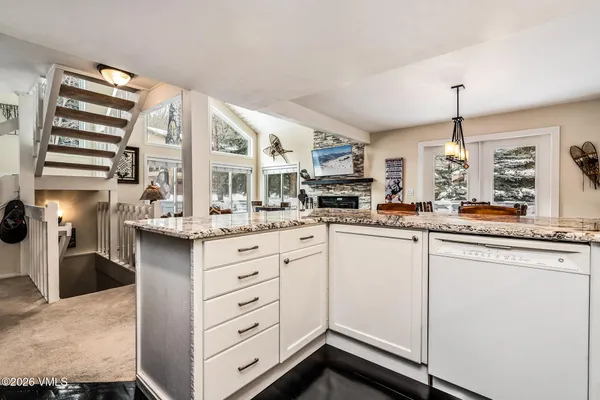 a kitchen with stainless steel appliances kitchen island granite countertop a sink and cabinets