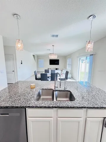 a kitchen with granite countertop a sink and a granite counter tops