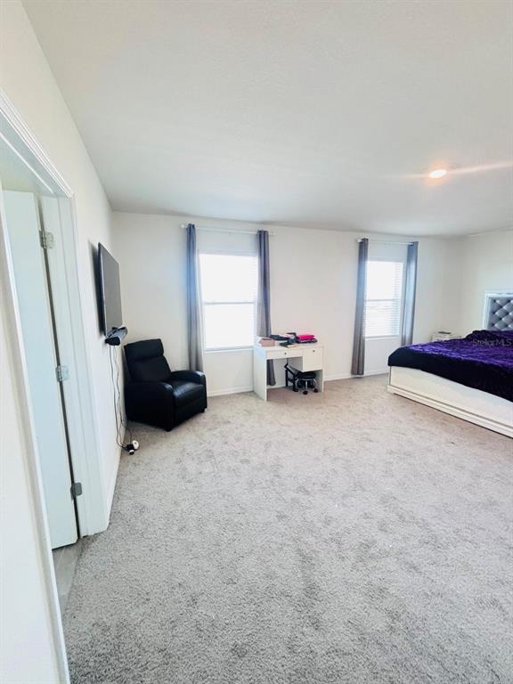 5185 Barombi Bend St. Cloud, FL 34772 - Photo 22 of 47 a living room with furniture and a large window