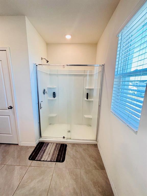 5185 Barombi Bend St. Cloud, FL 34772 - Photo 27 of 47 a bathroom with a bathtub and a shower