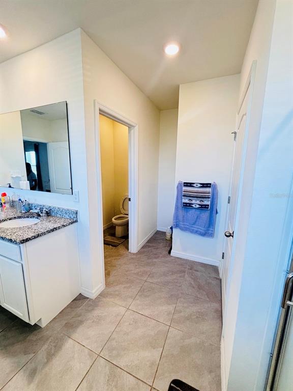 5185 Barombi Bend St. Cloud, FL 34772 - Photo 28 of 47 a view of room with granite countertop furniture and a hallway