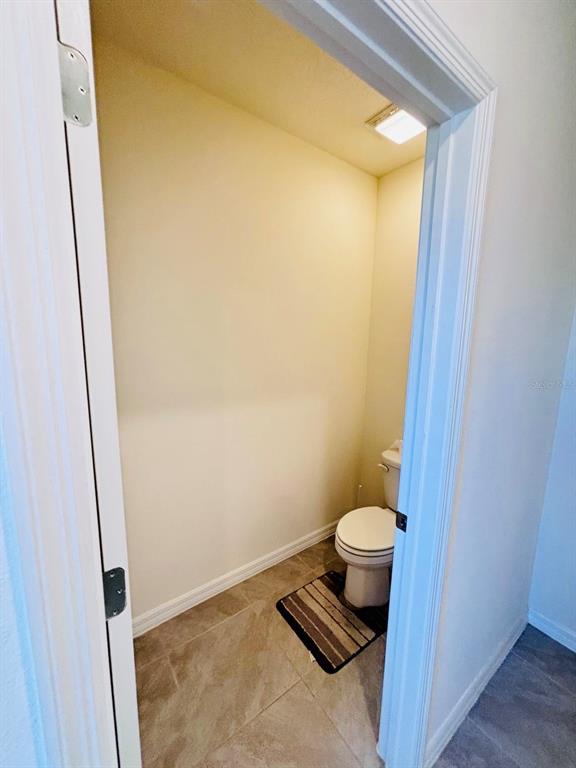 5185 Barombi Bend St. Cloud, FL 34772 - Photo 30 of 47 a bathroom with a toilet and a sink