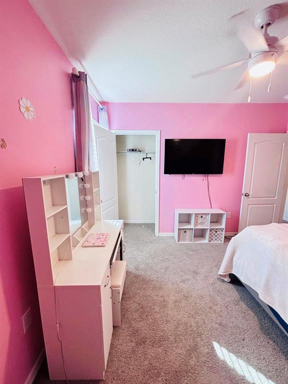 5185 Barombi Bend St. Cloud, FL 34772 - Photo 33 of 47 a room with furniture and a flat screen tv