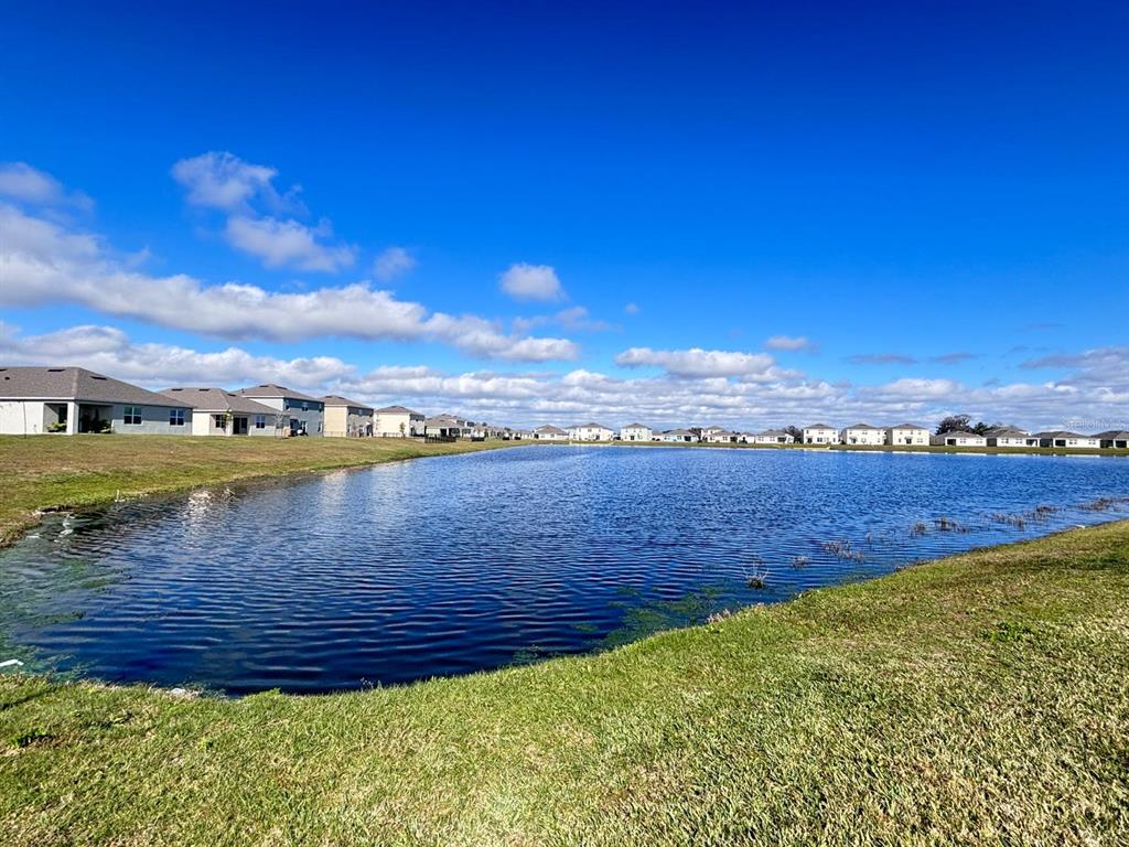 5185 Barombi Bend St. Cloud, FL 34772 - Photo 44 of 47 a view of a lake with houses in the back
