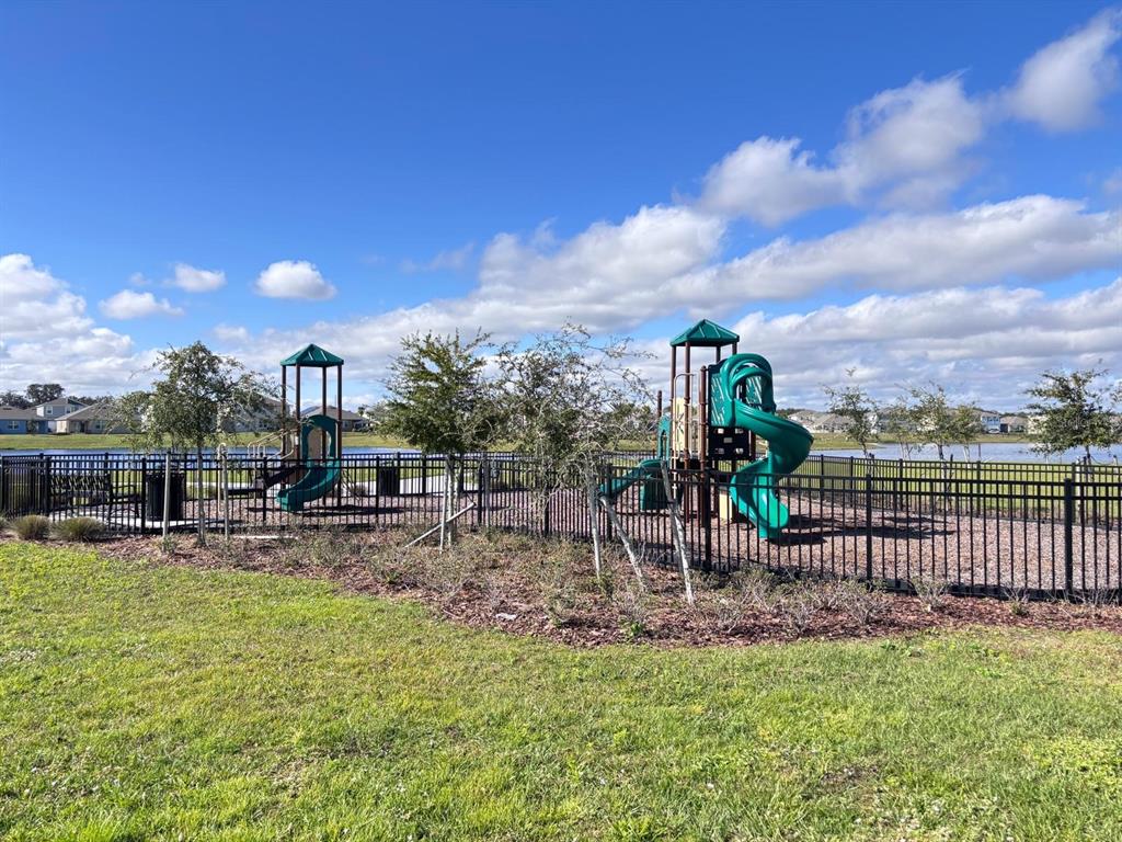5185 Barombi Bend St. Cloud, FL 34772 - Photo 46 of 47 a view of a lake with a garden