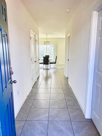 a view of a kitchen with a sink and a refrigerator
