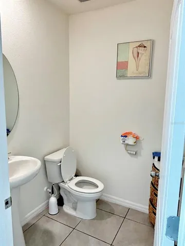 a white toilet sitting next to a bathroom sink