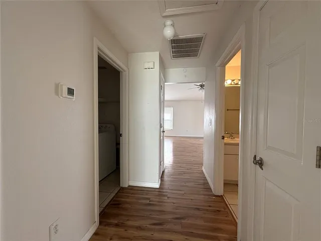 a view of hallway with wooden floor