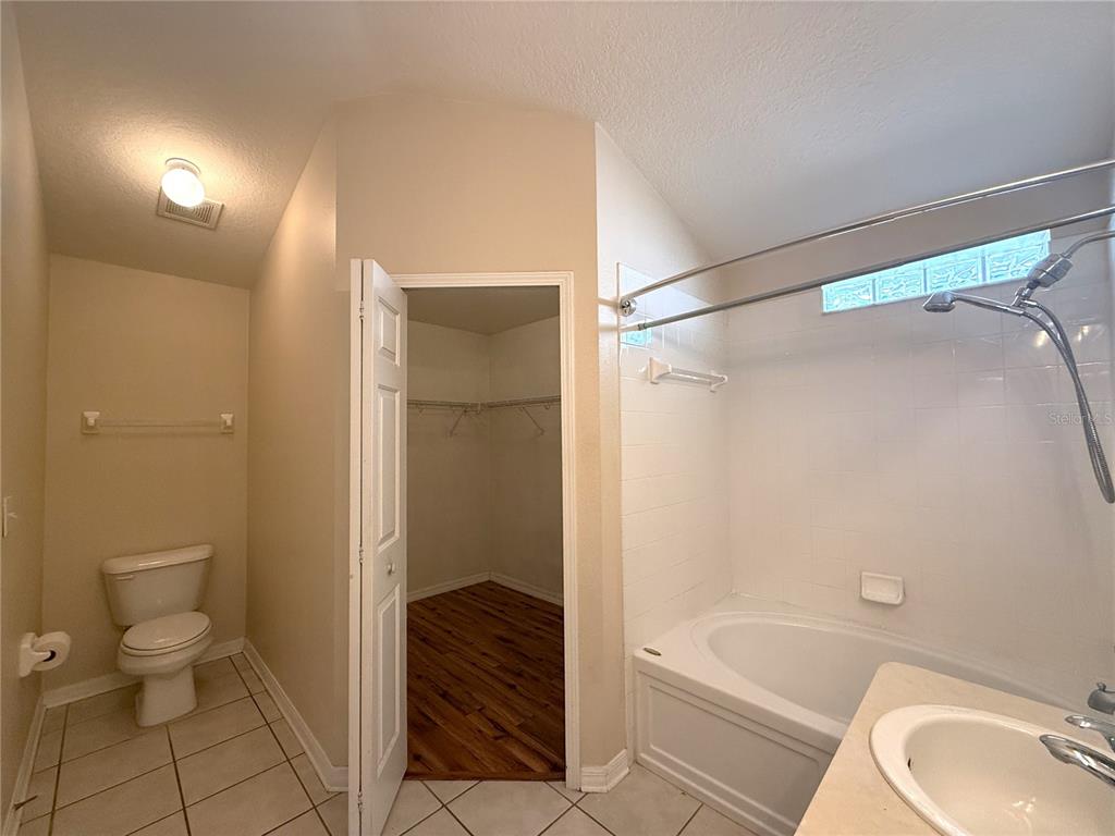 6518 Bridgecrest Drive Lithia, FL 33547 - Photo 10 of 26 a bathroom with a granite countertop bathtub shower sink and toilet