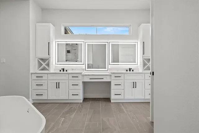 a bathroom with a sink vanity and a bathtub