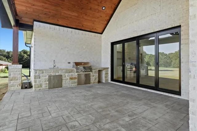 a view of a kitchen with a sink and a stove