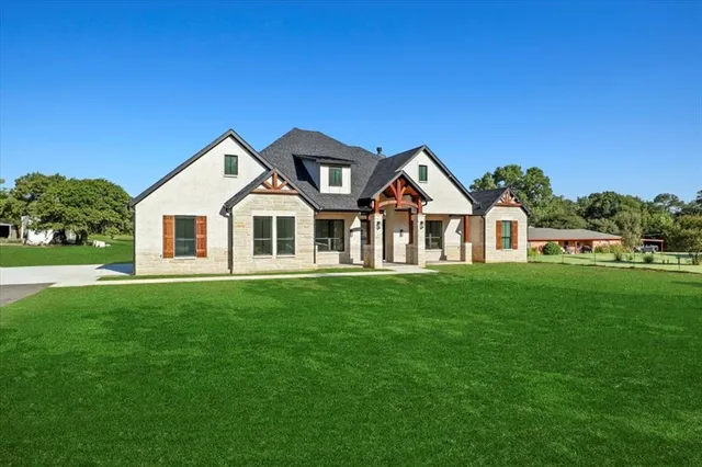 a front view of a house with a yard