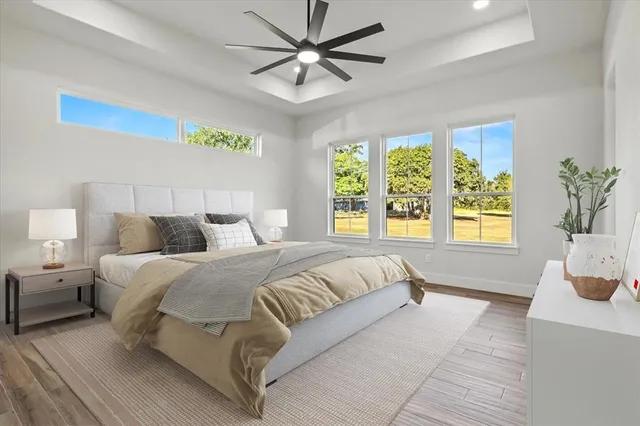 a spacious bedroom with a large bed and a chandelier